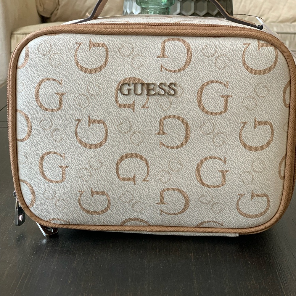 Guess white/ tan Cosmetic Bag with Monogram Pattern.